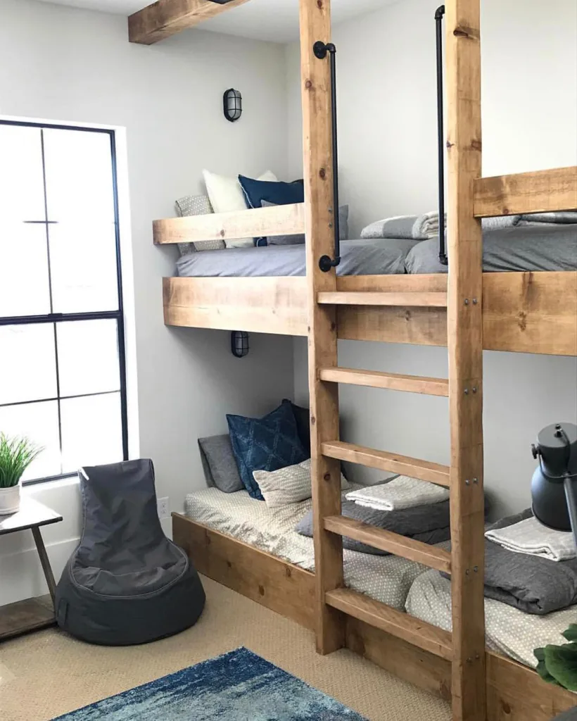 Rustic Wood Bunk Beds With Grey And Blue Accent Colors And A Wide Ladder.