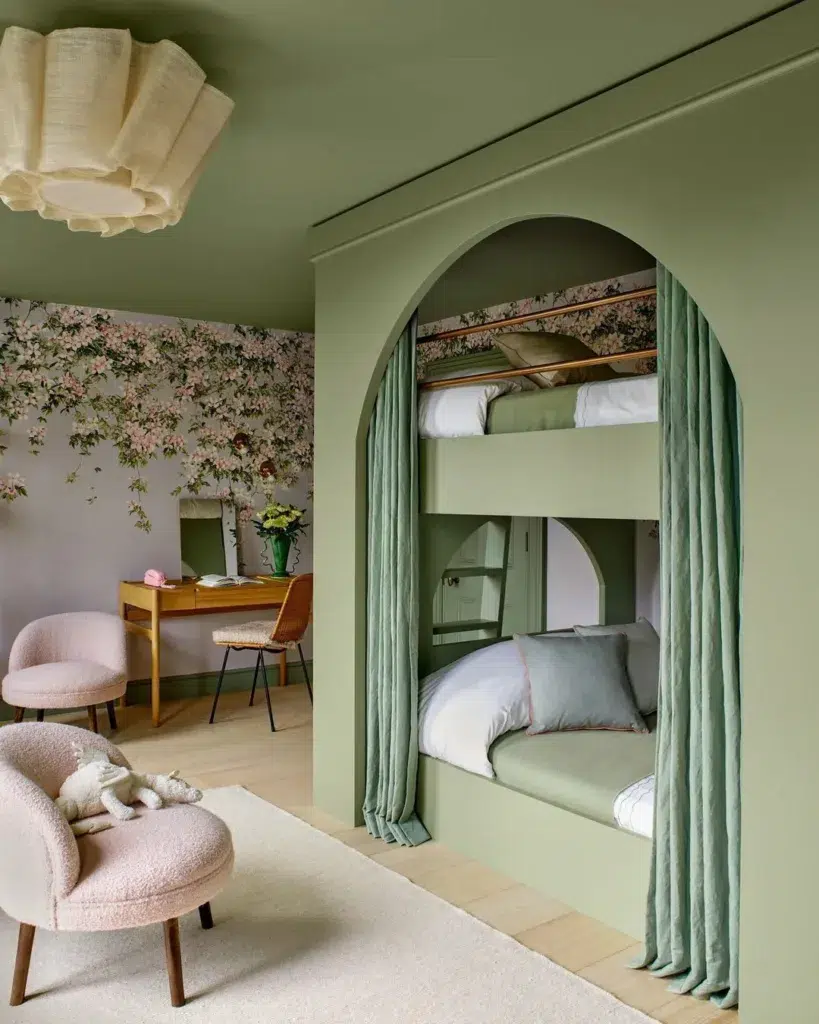 Green Bunk Beds Built-Into The Wall With Curtains And A Pink Accent Wall Nearby