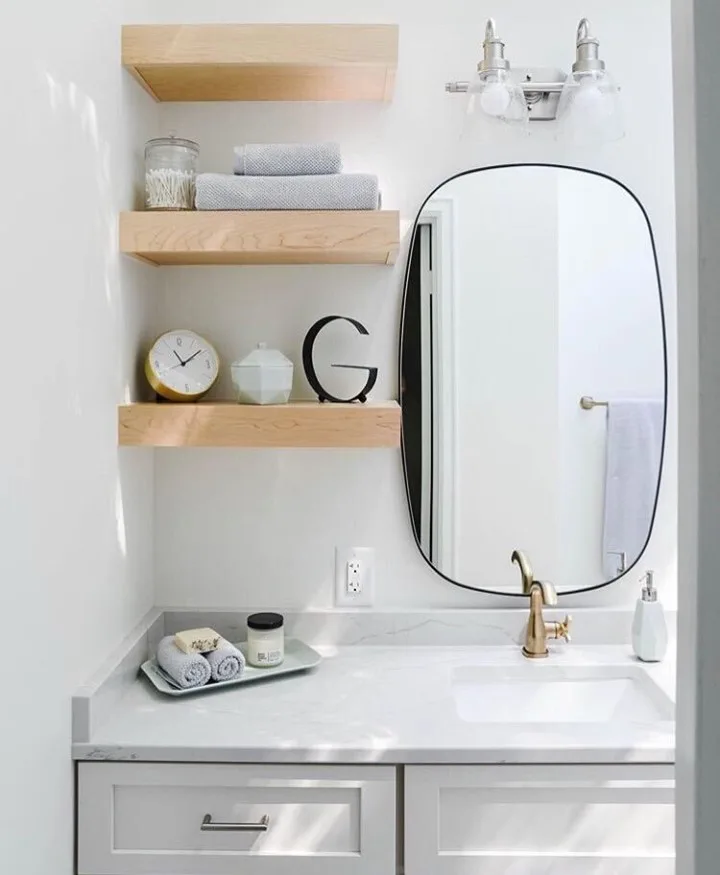 35 Bathroom Counter Decor Ideas 8 A Towel And Tray Below Open Wood Shelves In A Gray Bathroom