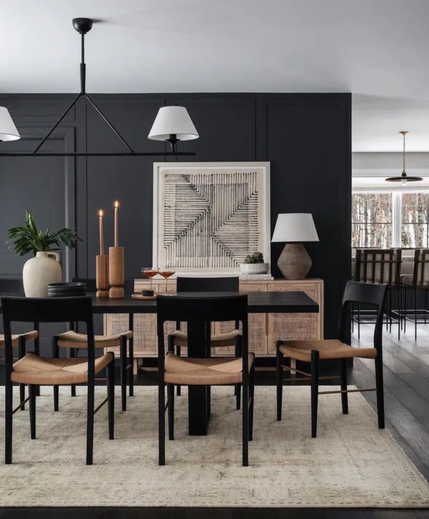 A Dark Dining Room With A Black Wall And Black Table And Chairs