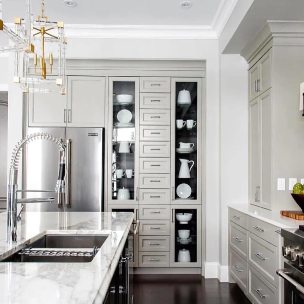 32 Floor To Ceiling Cabinets Ideas To Maximize Storage 16 The Cabinets Have Glass Doors And Several Items Displayed Inside, Including Plates, Glasses, And Bowls.