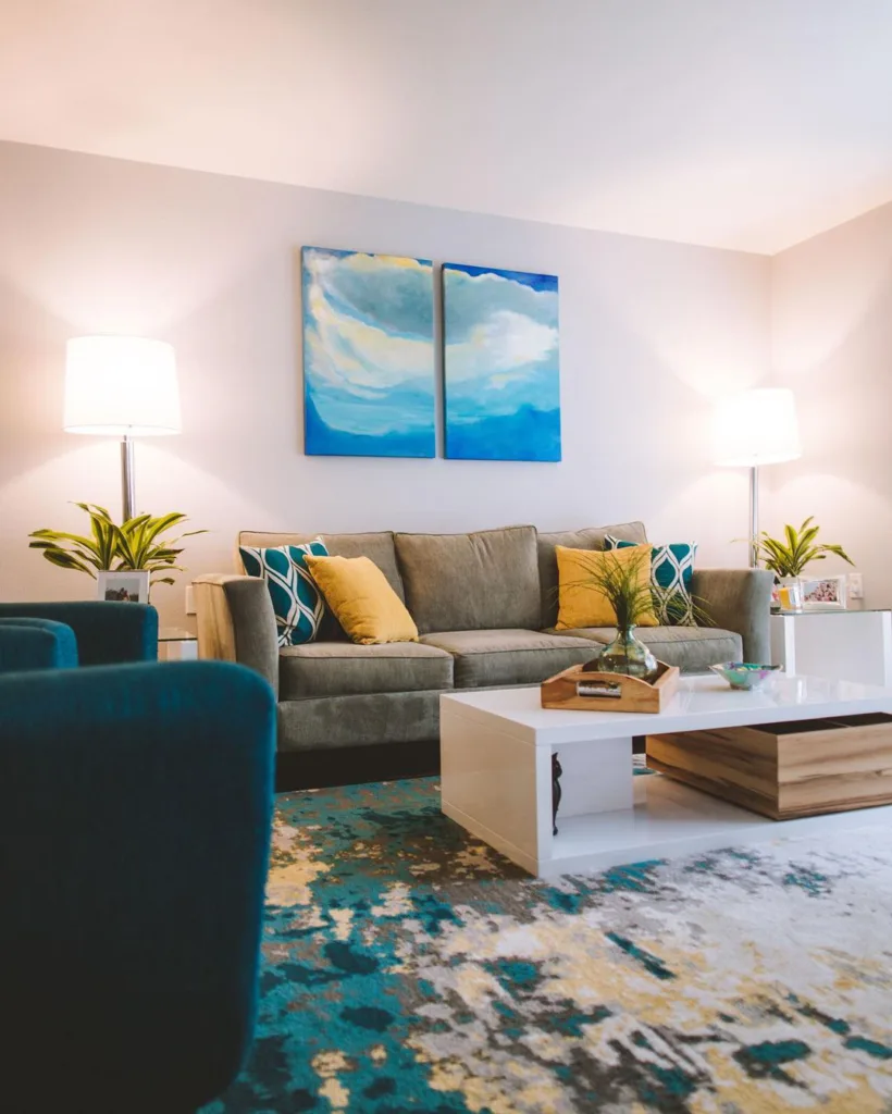 31 Coastal Beach-Themed Living Room Ideas 23 Pops Of Blue And Green With Throw Pillows, Curtains, And A Beach-Inspired Painting In This Living Room