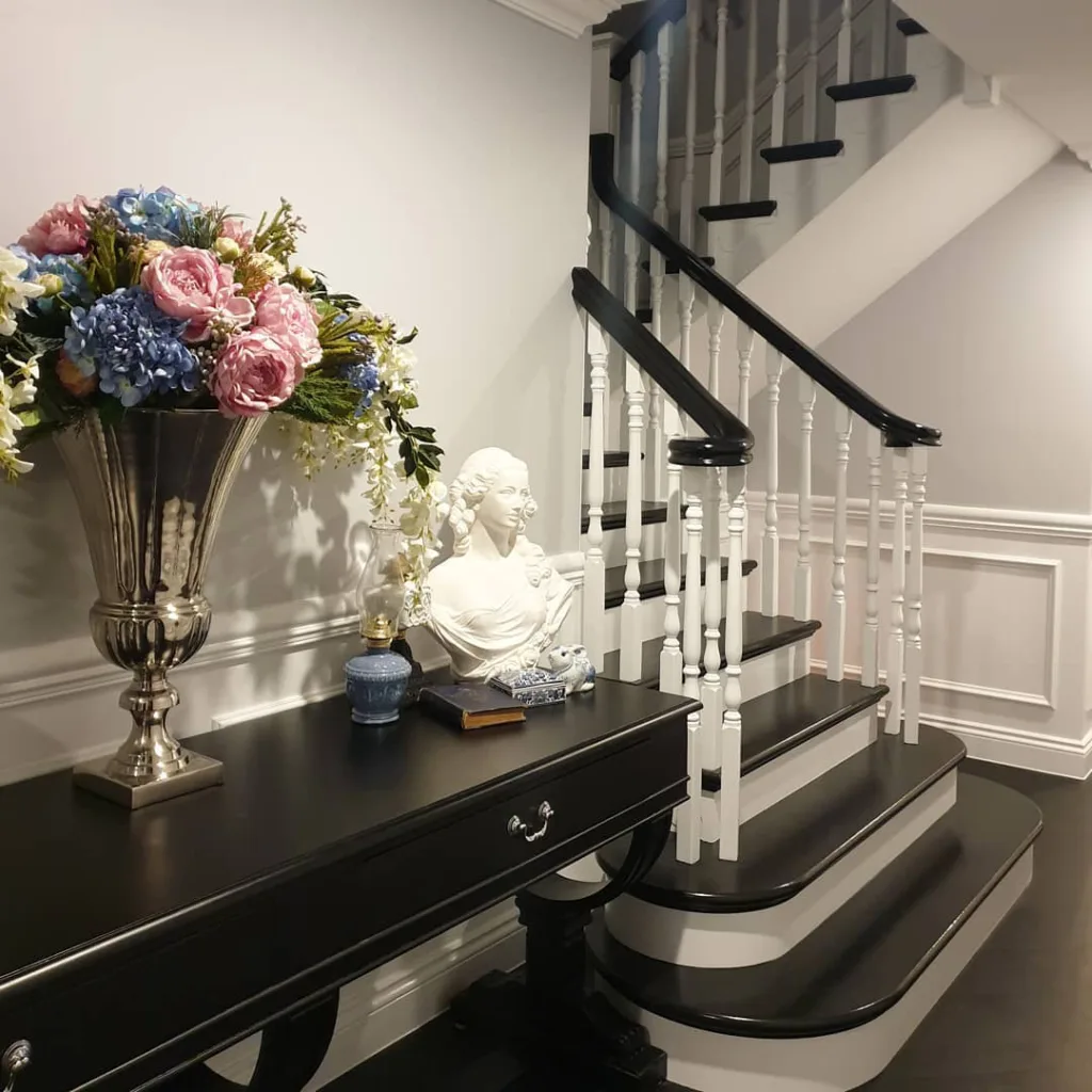 31 Black And White Stairs That Are Sure To Stun 21 Black And White Stairs Next To A Black Console Table And White Wainscoting