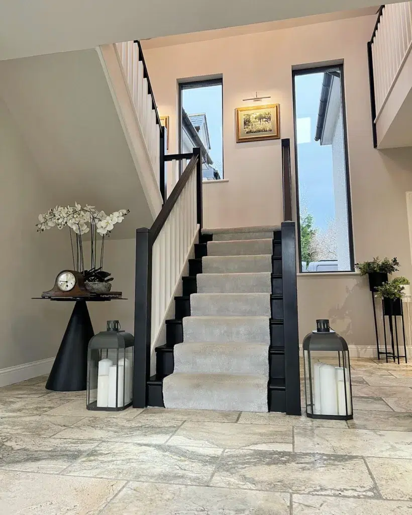 31 Black And White Stairs That Are Sure To Stun 7 Black Stairs With White Spindles And A Grey Runner In A Two-Story Entryway