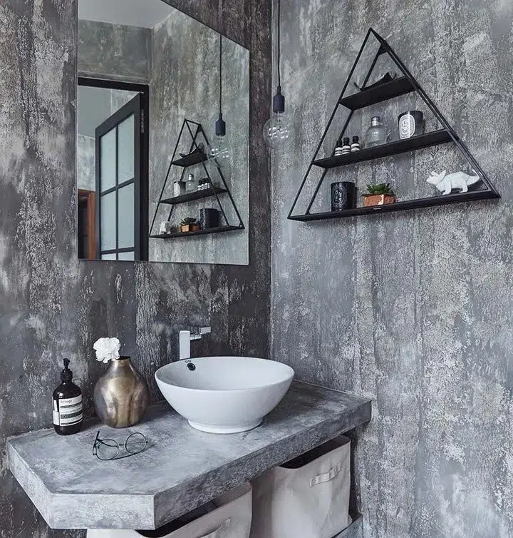 35 Bathroom Counter Decor Ideas 27 A Grey Cement Bathroom Vanity With A Gold Vase And Bottle Of Soap As Bathroom Decor