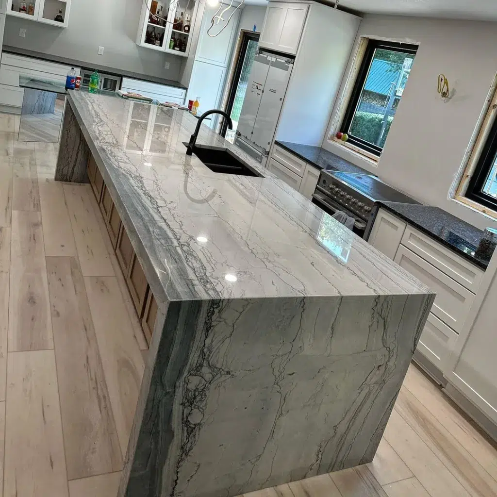 32 Waterfall Kitchen Island Ideas For Inspiration 2 A Grey Granite Island With A Waterfall Edge