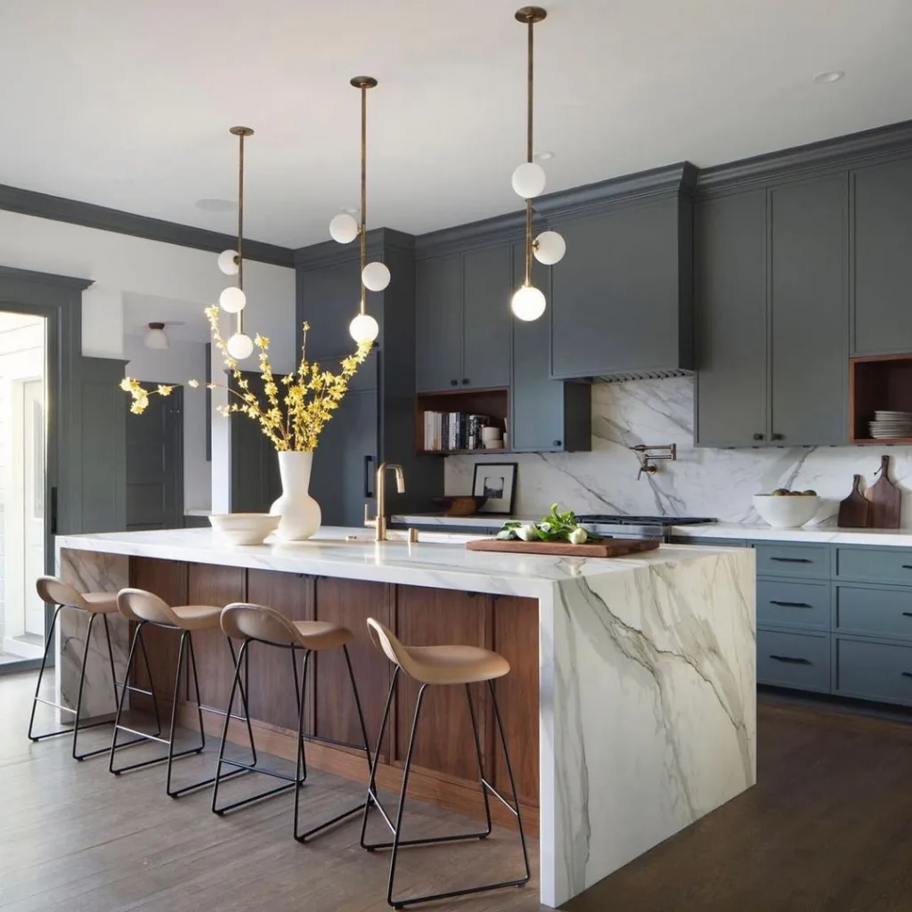 32 Waterfall Kitchen Island Ideas For Inspiration 6 A Marble Waterfall Edge Island With Brown Wood Accents And Green Cabinets
