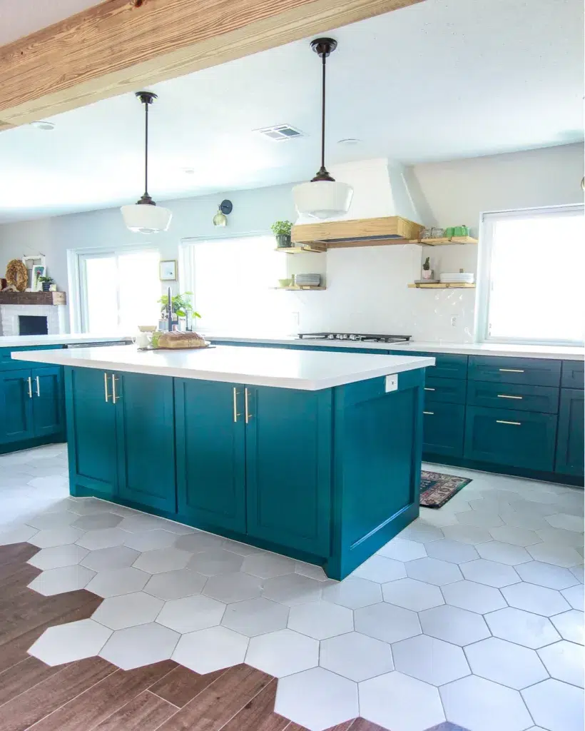A Luxurious Teal Kitchen With High-End Appliances, White Hexagon And Wooden Tiles.