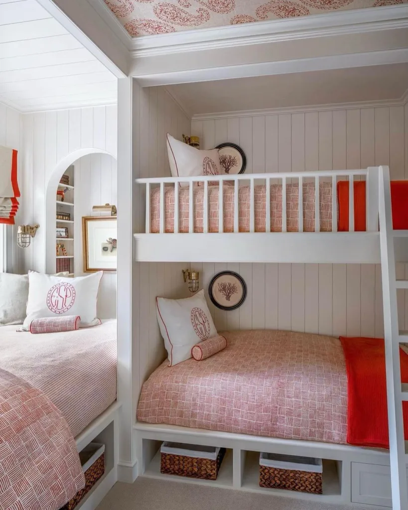 33 Built-In Bunk Beds To Upgrade Your Guest Rooms 18 A Girls Room With Two Bunk Beds Built-Into The Wall With Vertical Shiplap And Pink Bedding