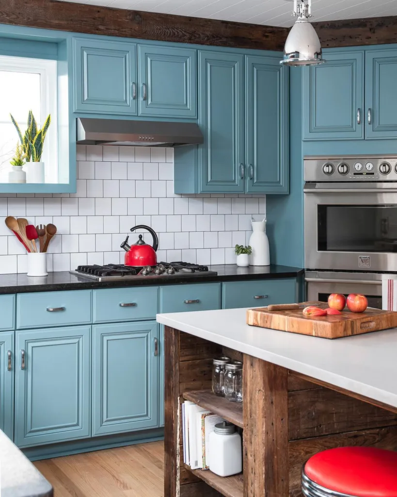 Antique Teal Cabinets With Black Countertops And White Subway Tile Backsplash
