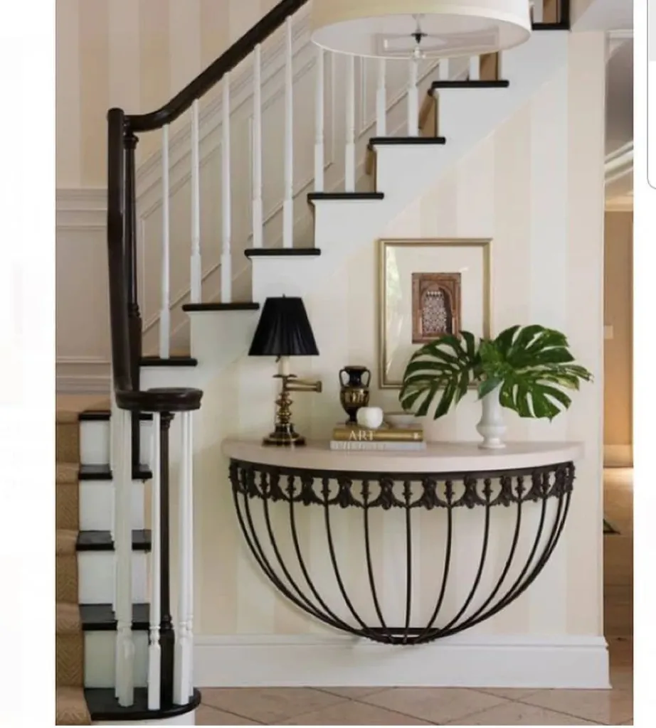 Black And White Stairs With A Beige Runner And A Matching Entryway Table Built Into The Wall