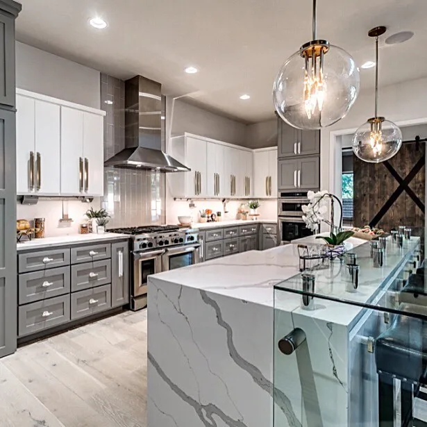 32 Waterfall Kitchen Island Ideas For Inspiration 3 Thick Grey Veins On The White Quartz Island That Has Plenty Of Seating With A Glass Overhang