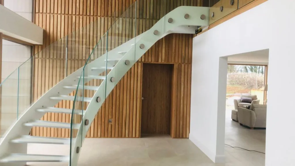Curved Steel And Glass Stairs, Awaiting Oak Treads With Wooden Background