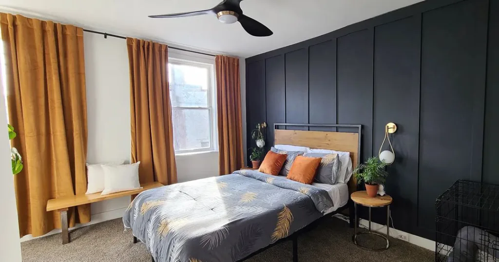 34 Black Accent Wall Ideas For Stunning Contrast 22 A White Room With A Black Accent Wall And Orange Accents