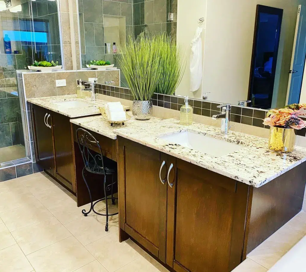 Minimalist Bathroom Counter With Sleek Marble Countertop, Neatly Organized Toiletries, And A Vase Of Fresh Flowers For A Touch Of Elegance.&Quot;