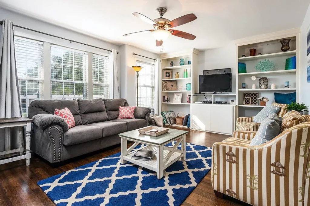 31 Coastal Beach-Themed Living Room Ideas 16 A Grey Sofa Across From Two Nautical Themed Accent Chairs In A Small Coastal Living Room