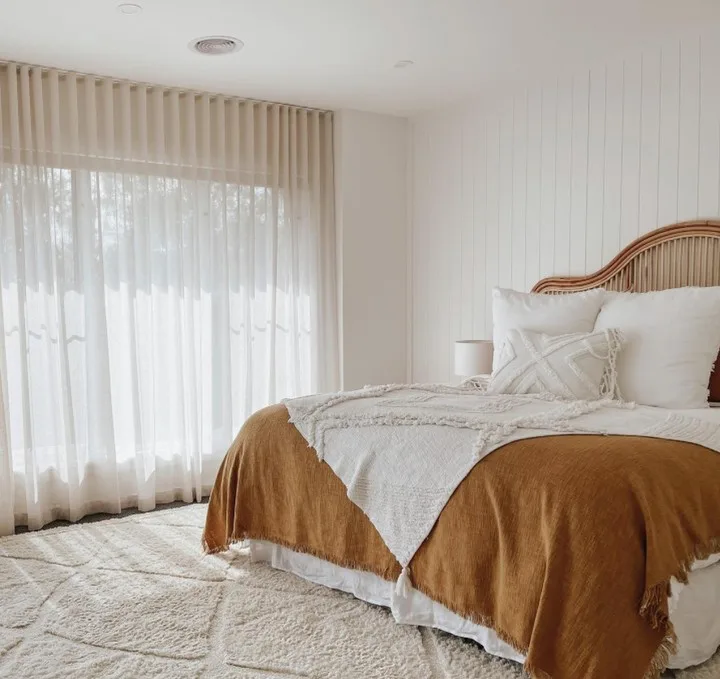 37 Rug Under Bed Ideas For A Stylish Bedroom 12 A Beige Rug With Texture Accenting The Orange And White Bedding On The Bed