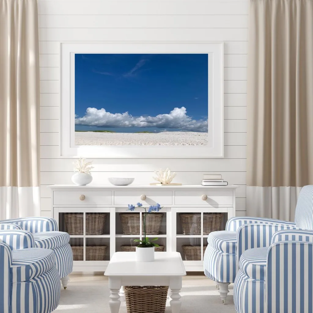 A Framed Picture On A Shiplap Wall With White And Blue Striped Accent Chairs For Seating In Front