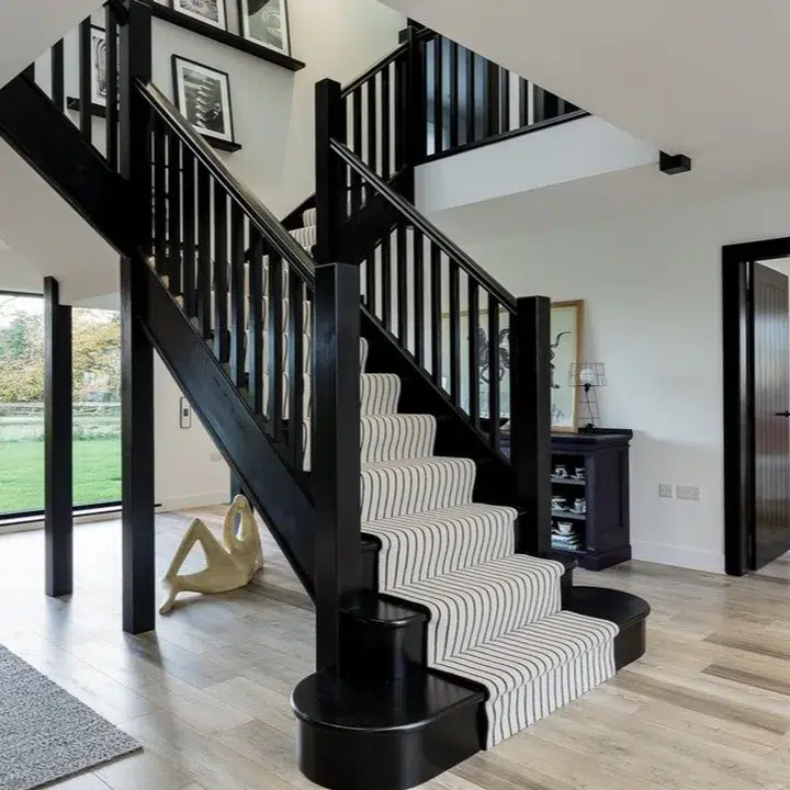 Black Stairs With A White And Black Runner 