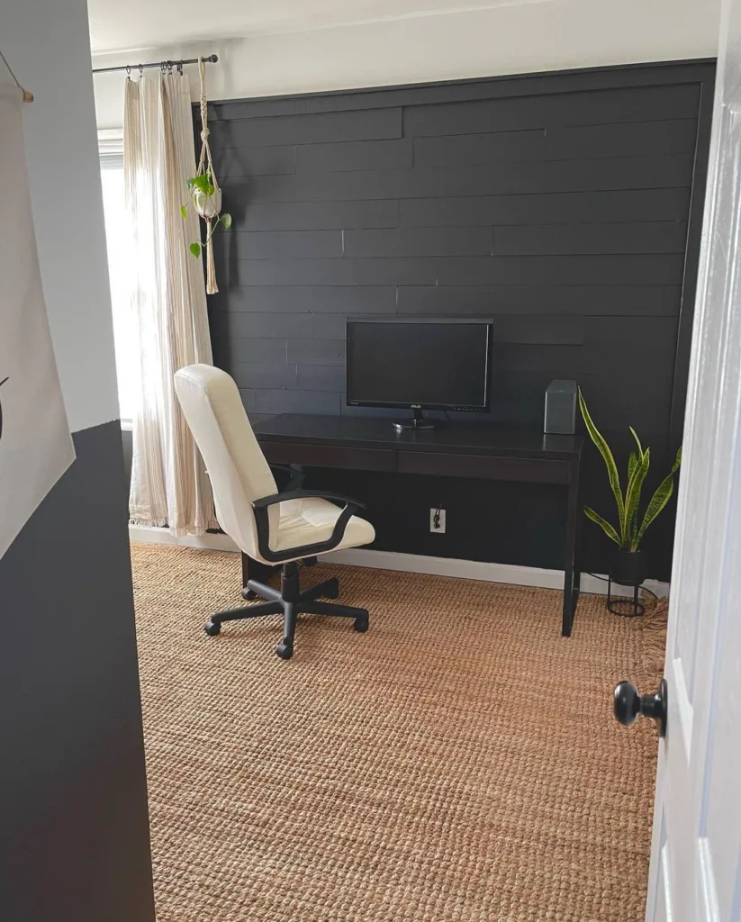 A Black Shiplap Half Panel Wall With A Desk And Chair