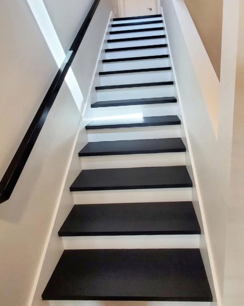 Modern Black And White Stairs With White Walls And A Black Railing