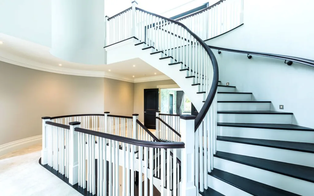 24 Curved Staircases For Design And Decor Inspiration 14 White And Black Wood Curved Stairs In A Home With Carpets