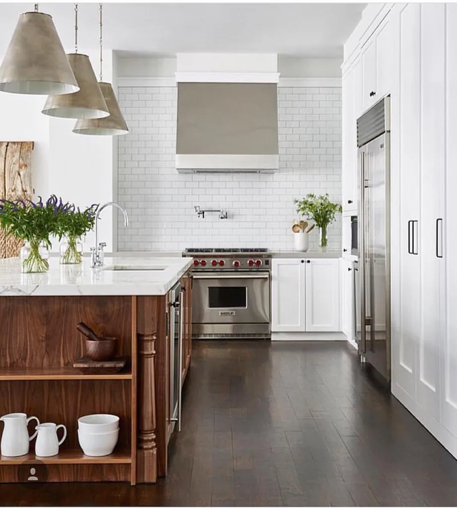 White Floor-To-Ceiling Cabinets In A Dark Hardwood Floor Kitchen