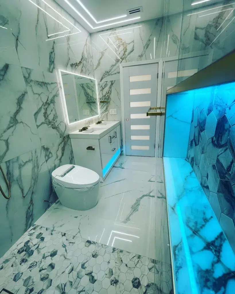 38 Bathrooms With Hexagon Tile Floors 9 A Luxurious And Elegant Bathroom Featuring A Hexagonal Tile Pattern On The Floor Made Of Marble, Creating A Stunning And Sophisticated Look. The Walls Are Also Made Of Marble, Adding To The Opulence Of The Space. A White Cabinet Provides A Clean And Minimalist Touch, While Also Offering Practical Storage Space. The Hexagonal Tiles Have A Polished Finish, Reflecting Light And Adding To The High-End Feel Of The Room