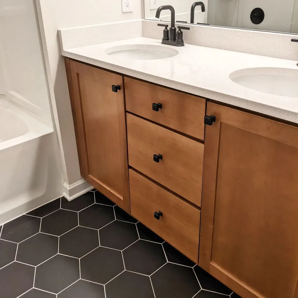 38 Bathrooms With Hexagon Tile Floors 5 This Tile Is Bold And Subtle At The Same Time. Next To The Sand Cabinets, White Countertops And Black Plumbing Fixtures, It Sure Does Make A Statement.