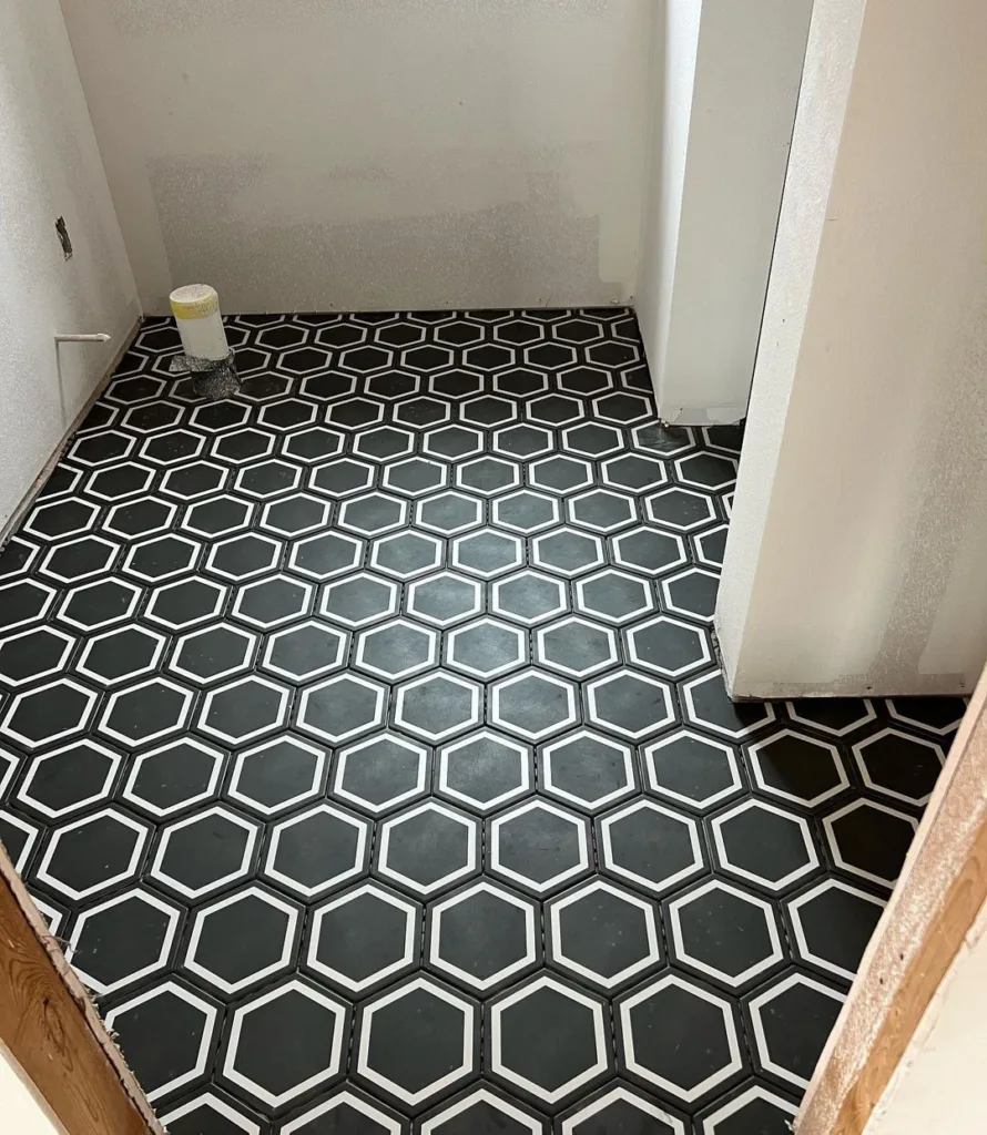 38 Bathrooms With Hexagon Tile Floors 15 A Classic And Timeless Bathroom Featuring A Striking Black And White Hexagonal Tile Pattern On The Floor, Creating A Bold And Stylish Contrast. The Walls Are White, Providing A Clean And Minimalist Touch. The Hexagonal Tiles Have A Matte Finish, Adding A Subtle Texture To The Space