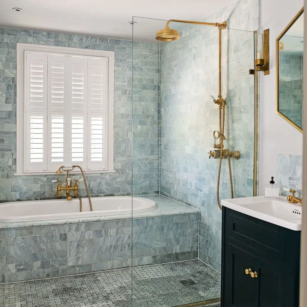 38 Bathrooms With Hexagon Tile Floors 23 Blue And Grey Tiles On Bathroom Wall With White Tub, Golden Bathroom Accessories, Small Hexagon Floor Tiles