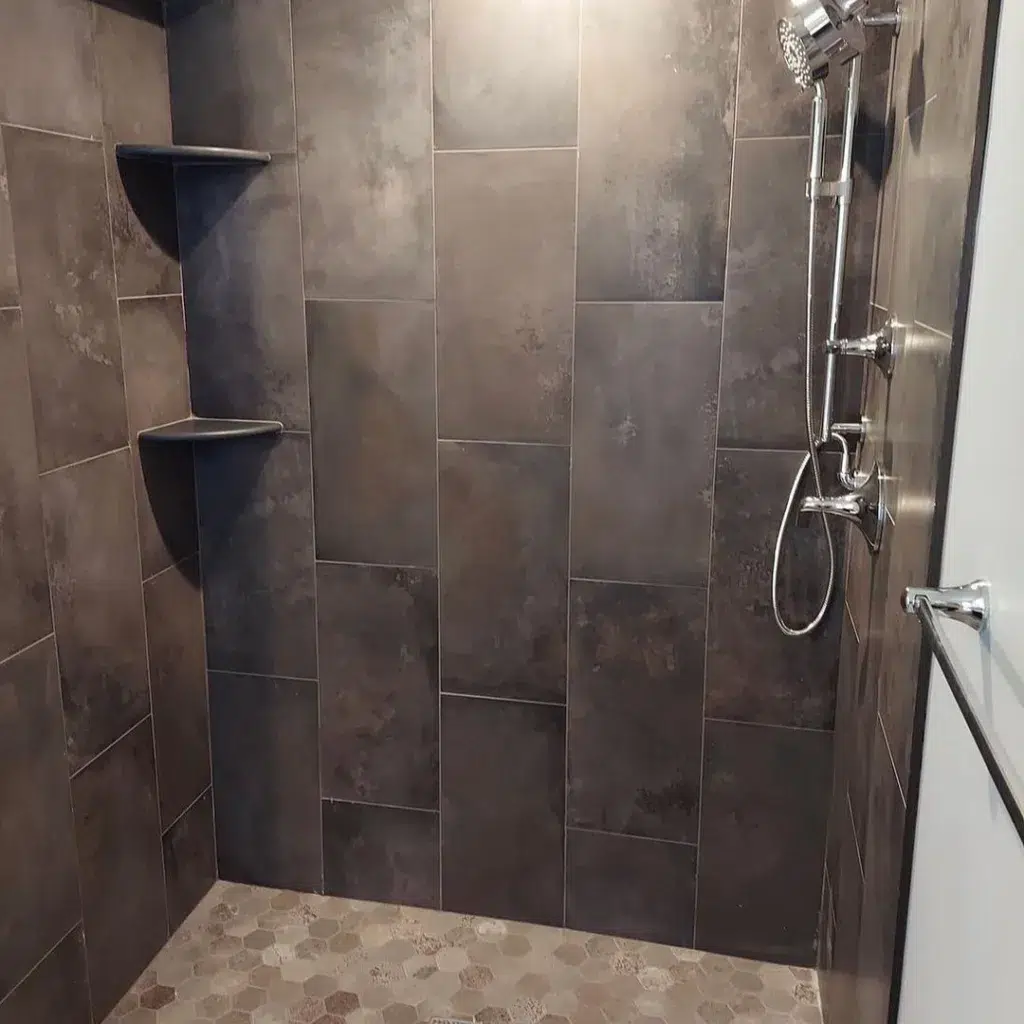 38 Bathrooms With Hexagon Tile Floors 12 A Bathroom Featuring Dark Wooden Walls That Create A Warm And Cozy Atmosphere, With A Hexagonal Tile Pattern On The Floor Adding Texture And Visual Interest. A Silver Tap On The Sink Adds A Touch Of Modernity And Shine To The Space. The Tiles Have A Matte Finish, Providing A Subtle And Understated Look That Complements The Wood. The Combination Of Wood And Tiles Creates A Harmonious And Rustic Feel, With A Focus On Natural Materials And A Cozy Atmosphere.