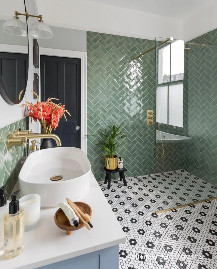 38 Bathrooms With Hexagon Tile Floors 32 A Vibrant And Charming Bathroom With Green Tiles Covering The Walls And A Stunning Floral Hexagon Floor. The Patterned Tiles In Various Shades Of Green Add A Playful And Cheerful Element To The Space, While The White Sink And Golden Plant Vase Bring A Touch Of Elegance And Sophistication. A Black Pot With Bright Red Flowers Serves As A Striking Accent, Adding A Pop Of Color To The Design.