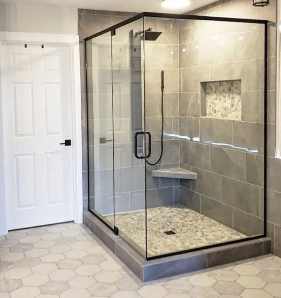 38 Bathrooms With Hexagon Tile Floors 6 A Minimalist And Modern Bathroom Featuring Cream-Colored Hexagonal Tiles On The Floor, Creating A Clean And Sleek Look. A Glass Partition Separates The Bathing Area, Adding A Sense Of Openness And Modernity To The Space. The Door Is White, Providing A Crisp And Clean Contrast. The Hexagonal Tiles Have A Polished Finish, Reflecting Light And Adding To The Modern And Sophisticated Vibe Of The Room.