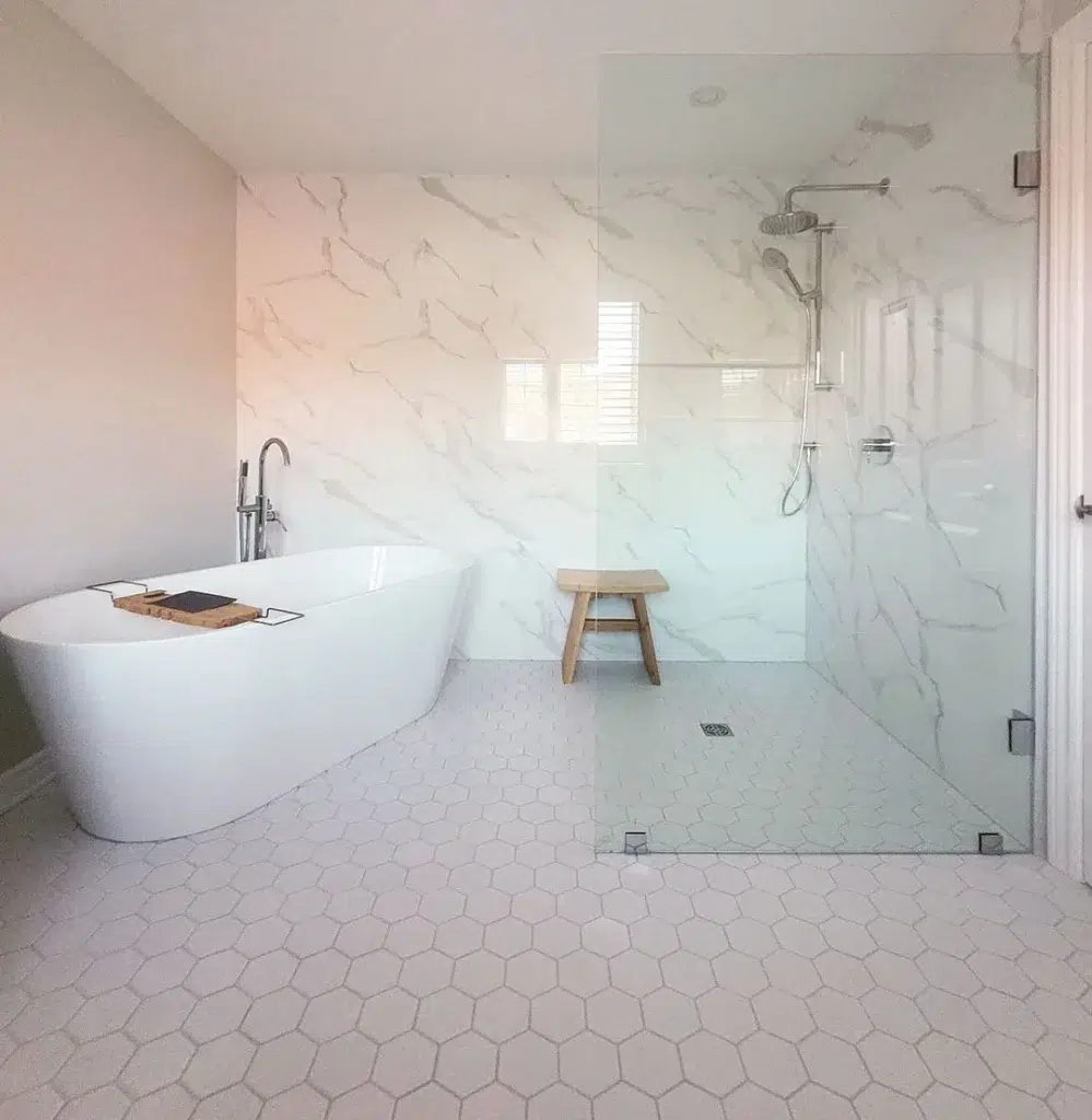 38 Bathrooms With Hexagon Tile Floors 37 White Hexagon Bathroom Floor Tiles With White Marble Walls And A Glass Enclosed Bathing Area With A White Tub